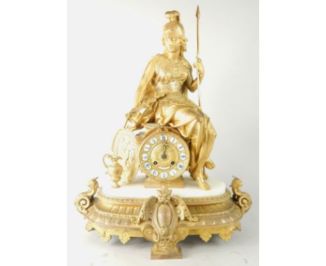 A 19thC French gilt metal mantel clock, the top mounted with a Britannia type figure, the dial with raised enamel Roman numer