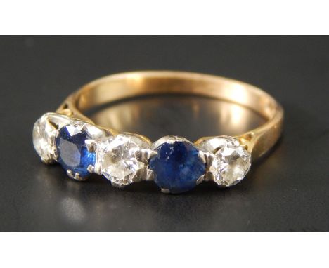 A sapphire and diamond five stone dress ring, set with three diamonds and two sapphires, yellow metal, marked 585, 2.7g all i