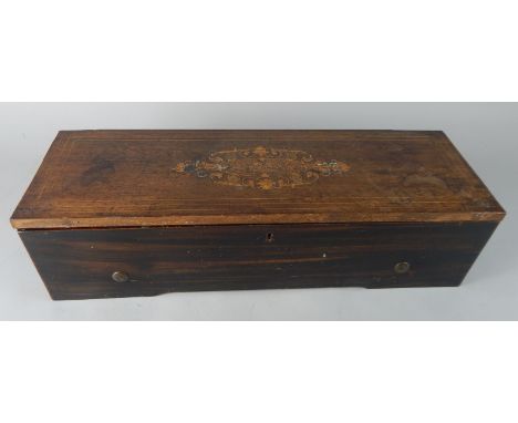 A late 19thC walnut cased cylinder music box, playing on eight airs, with brass cylinder in part glazed case, 14cm high, 51cm