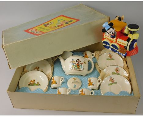 A Walt Disney ceramic figure of Mickey Mouse and Minnie, (AF), and an unusual Beswick Disneyland nursery teaset, with box and