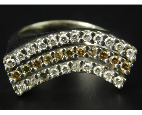 An 18ct white gold dress ring, with three rows of stones, two diamonds and one of yellow stone (one stone missing), with marc