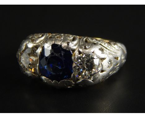 A Russian sapphire and diamond ring, with central sapphire approx 1.5cts, flanked by two old cut diamonds approx 0.85cts in t