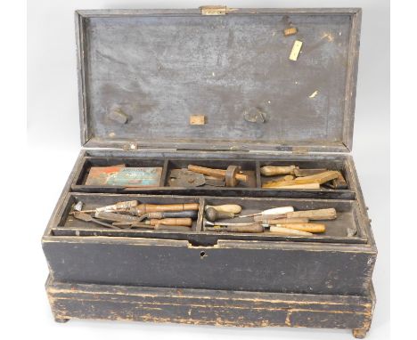 A late 19th or early 20thC ebonised pine tool chest, containing a large number of mainly woodworking tools, to include block 