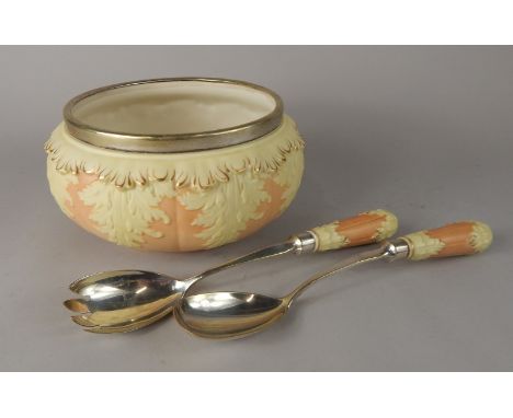 A Locke & Co Worcester porcelain salad bowl and servers, with raised decoration in cream with leaves, picked out in gilt, on 