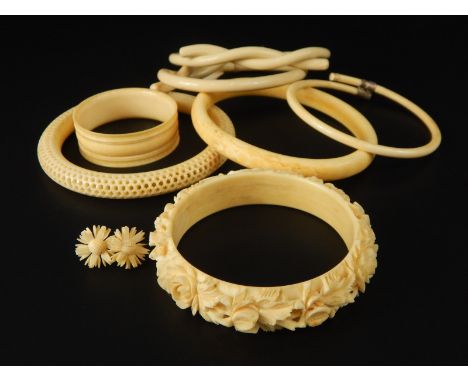 Various ivory and bone bangles, to include two bone cross over bangles, a pierced and worked ivory bangle, two antique bangle