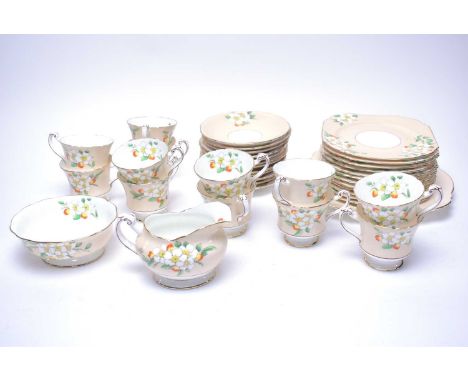 An Art Deco Paragon floral decorated tea service, decorated with white floral sprays on peach borders, comprising twelve tea 