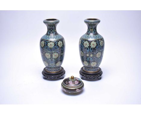 A pair of Chinese cloisonné enamel vases, each decorated with flowerheads and scrolling foliage in shades of blue, raised ove