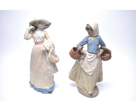 A Nao figure of ‘Pescadora de Vacio’, modelled as a fisherwoman, 36cms high, with box; together with another Spanish figure o