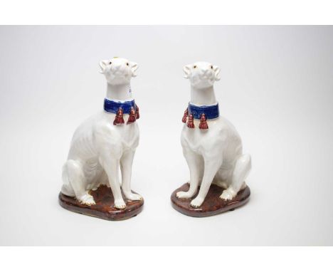 A pair of Chinese ceramic figures of dogs, 36cms high.