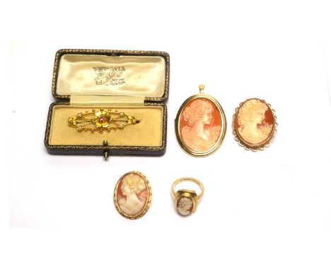 A 9ct yellow gold, amethyst and seed pearl brooch, of floral design, 2.0g gross; three carved shell cameo brooches, all with 