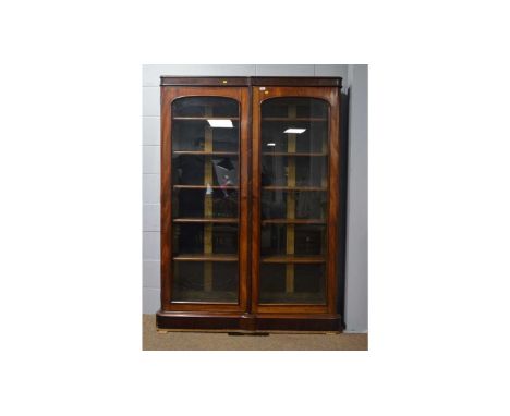 A Victorian mahogany bookcase, fitted a pair of arched glazed panel doors with ribbon and pole edging, enclosing adjustable s