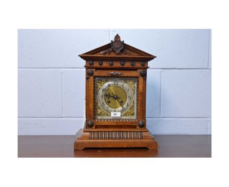A late 19th Century German oak bracket clock, with silvered arabic dial, gilt spandrels, two-train movement striking on a gon