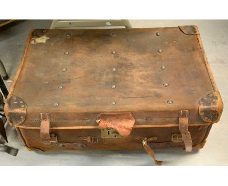 A vintage cabin trunk, in heavy brown hide, with stencilled initials 'J.I.S', gingham-lined, with wooden runners to base, 77 
