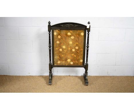 A Victorian carved and ebonised firescreen, with central floral needlework long and short stich panel and arched frame, turne