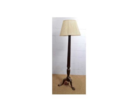A Victorian mahogany standard lamp, the tapering reeded pillar support raised over three carved legs, terminating in ball and
