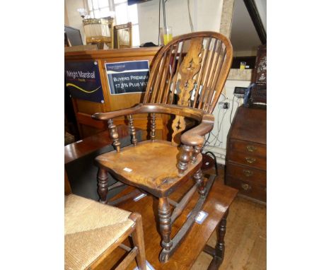 A 19th Century elm seated rocking chair with turned supports and stick and splat back 