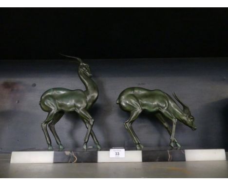 An Art Deco style bronzed spelter models of two Antelope set on a marble plinth base 