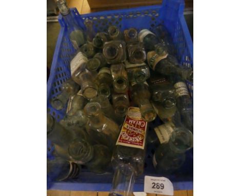 A box of vintage chemist bottles bearing Victorian labels 