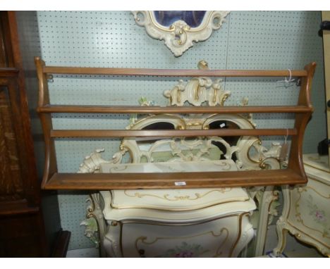 An Ercol light elm plate rack 