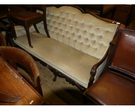 A Victorian sofa with show wood frame, scrolled arms and short cabriole legs, upholstered in a mushroom coloured buttoned fab