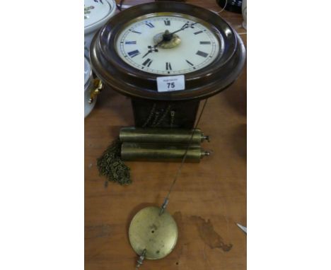 A late 19th/early 20th Century postman's alarm clock in circular stained wooden case, complete with pendulum and two weights.