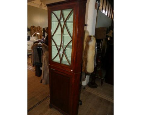 A 19th Century mahogany floor standing corner cabinet the top section with astragal glazed door, the bottom section with sing