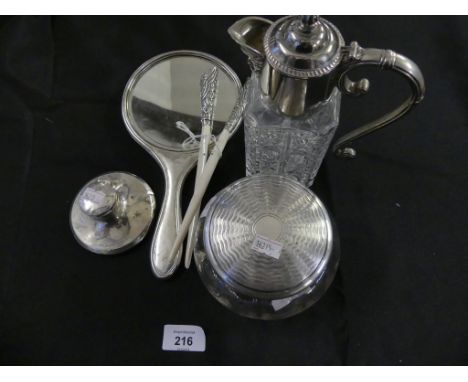 A selection of silver and white metal items to include a silver backed mirror, a silver lidded glass pot, a silver inkwell an