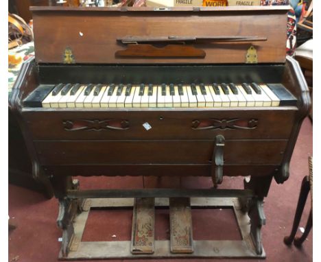 An 81cm antique mahogany cased travelling harmonium with flanking carrying handles