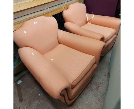 A pair of Art Deco style armchairs with pink machine tapestry upholstery, set on turned legs