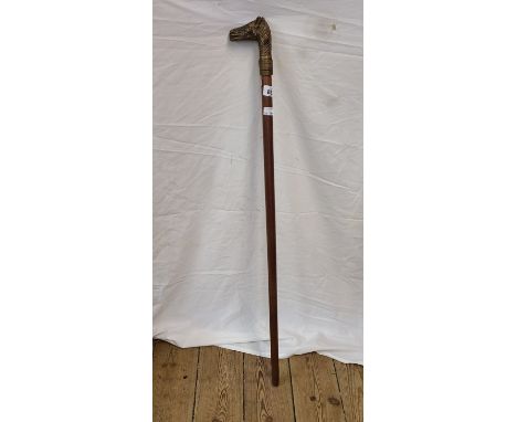 A modern walking stick with cast brass horse head pattern handle