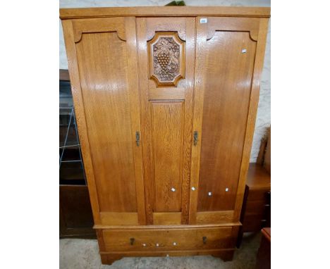 A 1.2m vintage light oak triple wardrobe with hanging space enclosed by a pair of panelled doors, with long drawer under, set