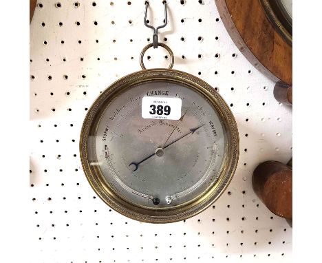 An antique brass cased sedan style wall barometer with silvered dial, two curved themometer scales and aneroid works