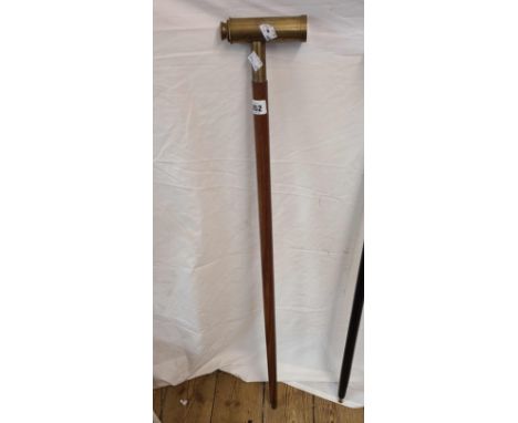 A modern walking stick with brass telescope handle