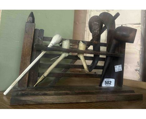 A wooden pipe rack in the form of a gate - sold with various pipes