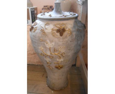 A large ceramic pot with antiqued finish, decorative overlay and wooden lid - decoration loss