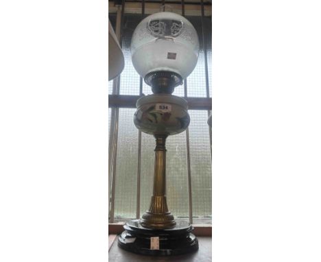 An antique oil lamp with hand painted reservoir and opaque glass shade
