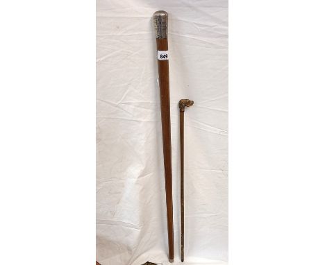 A silver topped walking stick with the inscription 'Presented to you Sergt. Blowey by his old comrades by the first division 