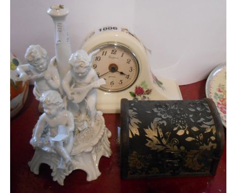 An Italian pottery figural table lamp base, depicting a putti band - sold with a ceramic mantel clock and a small decorative 