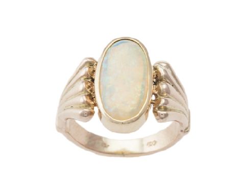 An opal and 9 carat gold ring, the oval cabochon opal between fanned graduated 9 carat gold shoulders, ring size M 