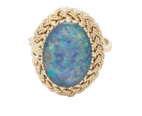 An 18 carat gold dress ring, composed of an oval synthetic opal cabochon within a finely woven 18 carat gold setting, ring si