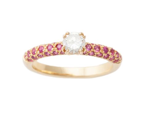 A diamond single-stone ring, composed of a round brilliant-cut diamond raised between circular-cut ruby set shoulders, to an 