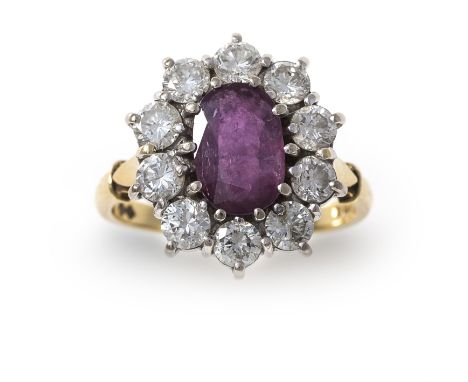 A diamond and ruby ring, the oval mixed-cut ruby to a surround of round brilliant-cut diamonds, within an 18 carat gold setti