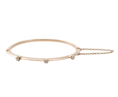 A Victorian diamond and 15 carat gold bangle, the hinged bangle with a trio of old round brilliant-cut diamonds to front, dia