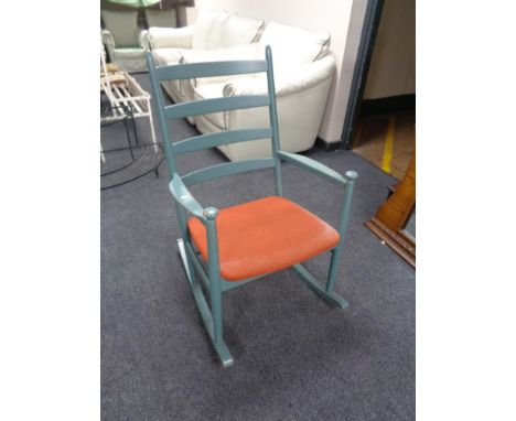 A mid century ladder backed rocking chair 