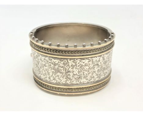 A fine late Victorian silver cuff bangle with engraved decoration CONDITION REPORT: 63.6g