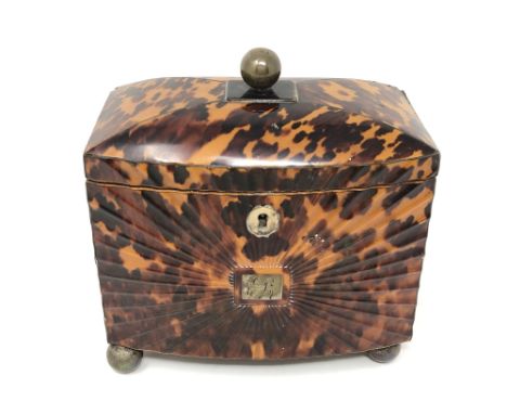 A Regency tortoiseshell tea caddy, circa 1820, the rectangular bowfronted caddy with scalloped front around a central cartouc