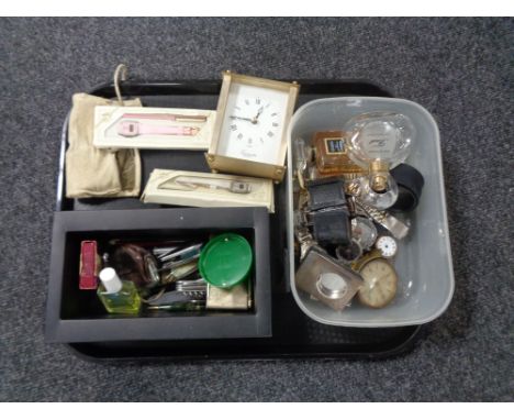 A tray of assorted wristwatches, perfume bottles, mantel clock, travel clock, pocket knives etc. 
