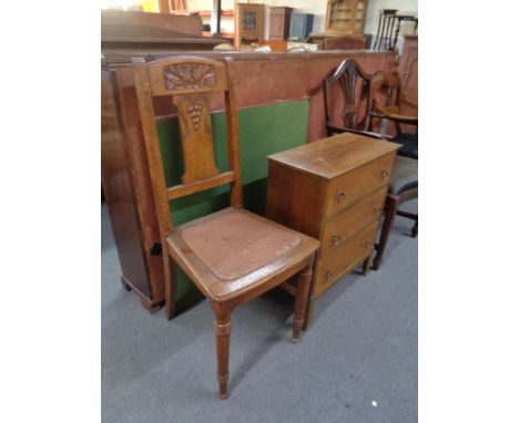 A carved oak occasional chair, three drawer chest and a card table 