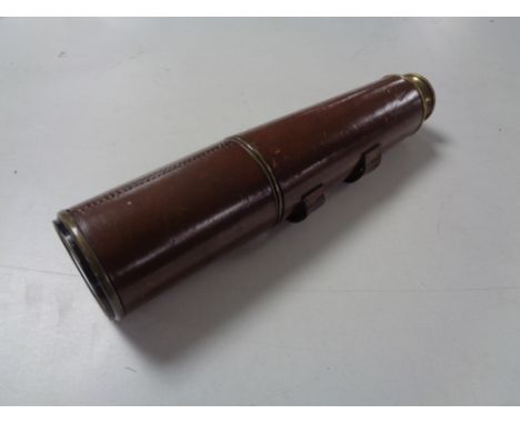 An antique brass leather bound nautical telescope. 