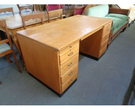 A mid 20th century oak twin pedestal desk 